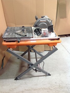 lot 300 image: RIDGID 9 Amp Corded 7 in. Wet Tile Saw with Stand in working conditions