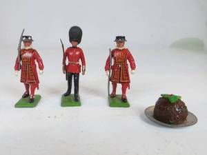 lot 47 image: 3 Metal British Guard Toys & 1 Figgy Pudding