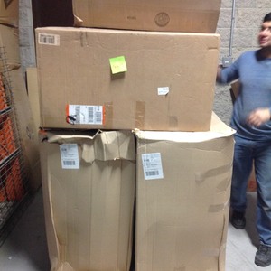 lot 28 image: Pallet with assorted storage totes and Cabinet customer returns