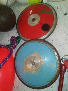 lot 499 image: Misc. Sporting goods, Jump Rope, balls, frisbees  more, shot put (2) discus (2). Loc class rm 101