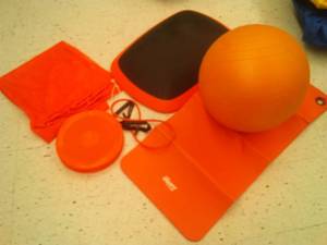 lot 769 image: Orange Exerfit Rainbow exercise set. Includes mat ball, Balance Disc and more. Loc class rm 101