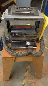 lot 153 image: Ryobi 12-516 in. Planer AP 12 on rolling wood rack and manual