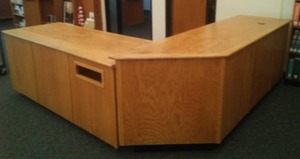 lot 590 image: Library Front Desk. Straight Desk Measures, 73in. x 29 x 32 and   Angle 8 ft. x 17 in. x 34 in. Loc Rm 111 Lbry