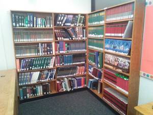 lot 591 image: Oak Wood Corner Bookcase with contents. 70.25 W x 83.5 H x 9 in. D Loc Rm 111 Lbry