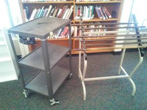 lot 614 image: Rolling media cart and hanging paper display. Loc Rm 111 Lbry