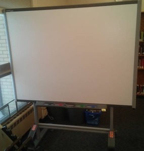 lot 615 image: Portable Smart Board by smarttech.com on roller frame. 65 in. x 49 screen measurement. Adjustable height, wheel locks, stabilizing legs and more. Loc Rm 111 Lbry