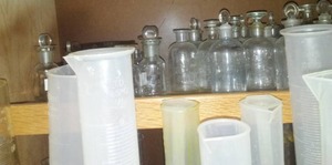 lot 522 image: Misc. Science Chemistry Supply Cupboards (2). Burners stands beakers, measuring tubes and more. Loc Rm 99 Sci