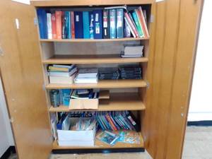 lot 424 image: Large wood storage cabinet with contents.