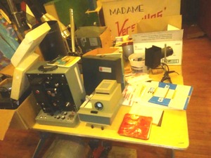lot 705 image: Vintage Photography  Huge Lot. Doran (NEW in box) Flashbulbs (NEW), lighting, cameras, dark room equipment, film, vintage tables (2) Loc 3-Prop Rm