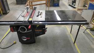 lot 151 image: Saw Stop Table Saw. $4,000 New  LIKE NEW Will NOT cut your finger off T Glide Fence System Industrial Series with Push stick brush, owners manual and DVD. Amazing