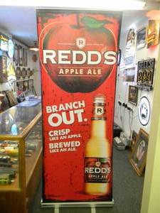 lot 15 image: REDS APPLE ALE BEER - Retractable display banner stand  easy to set up and take down OR CAN BE HUNG - LARGE VERY COOL APPROX 30 X 80 - SEE PICTURES