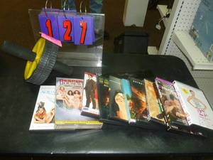lot 127 image: 11 Dvds & Exercise wheel. As shown. SEE TERMS