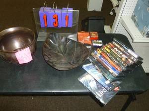 lot 131 image: 12 Dvds & other misc. decorative pieces. As shown. SEE TERMS