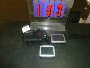 lot 143 image: GarminSpeckTom Tom Navigation units & 1 cord. As shown. SEE TERMS