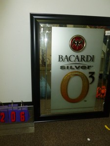 lot 206 image: Bacardi 26 x 32 mirror. Has small crack as show in pictures. As shown. SEE TERMS