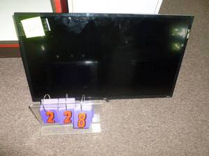 lot 228 image: TCL Roku TV 32 with wall bracket & remote. As shown. SEE TERMS
