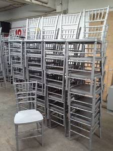 lot 105 image: Lot of (Approximately 25) Drake Corp. 36in. SilverGrey Stackable Plastic Banquet Chairs