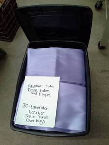 lot 345 image: Lot of (30) Eggplant Satin Dcor Fabric and Drapes, Lavender Satin Table Overlays 60x60in.