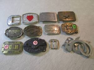 lot 122 image: Assorted Belt Buckles and Handcuffs...