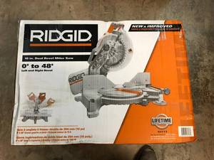 lot 209 image: RIDGID 15 Amp 10 in. Dual Miter Saw with LED Cut Line Indicator not used