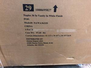 lot 210 image: Home Decorators Collection Naples 36 in. W Bath Vanity Cabinet Only in White with Right Hand Drawers not used damage on the back side side go to wall stock photo used to display the unit