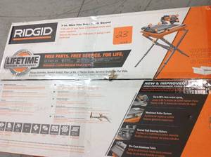lot 23 image: Ridgid 9 Amp Corded 7 in. Wet Tile Saw with Stand used in very good condition