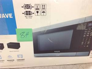 lot 84 image: Samsung 1.9 cu. ft. Countertop Microwave with Sensor Cook in Stainless Steel in good condition