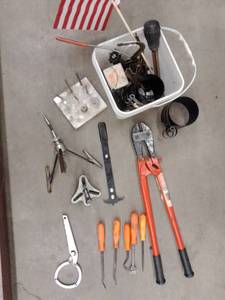 lot 889 image: Misc. Bucket of Tools and more. Bolt Cutter, Chisels, Pry bars, Large Cylinder Hone and more.