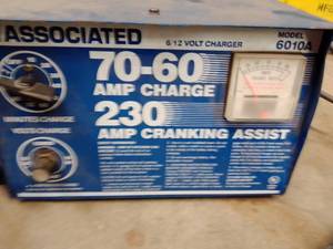 lot 1135 image: 230 Cold Cranking Amp Charger and Shop Creepers (2).