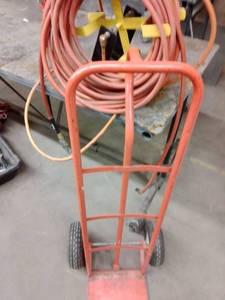 lot 1144 image: Hand Truck and Air Hose with mounting holder. Loc shop