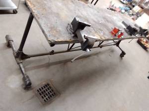 lot 1403 image: Roller Table with vices (4) 3 x 10.5 ft. x 39in easy removal through overhead door.