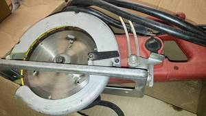 lot 1098 image: Milwaukee heavy duty worm drive saw and drill.