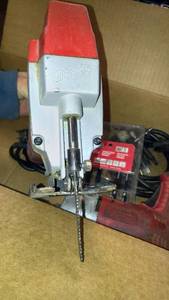 lot 1100 image: Milwaukee heavy duty jigsaw with extra blades and drill.