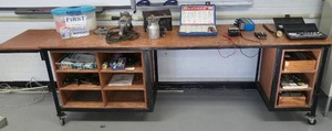 lot 1105 image: Rolling large desk112x 26x 32  with contents. First aid kit, tools. Spray gun and much more