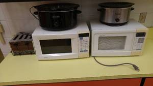 lot 1443 image: Microwaves (2) Crock Pots (2) 4-slice toaster.