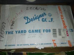 lot 831 image: Golf supplies, shag bag, putting cups, backyard golf, shelving and more.