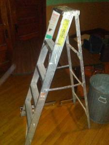 lot 854 image: 4 x2 tables (2), 5ft step ladder, Costco stool and can.