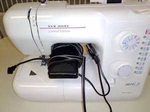 lot 1243 image: New Home 2014 LE Sewing Machine with table.