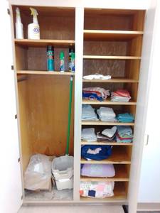 lot 1245 image: Contents of Closets, Misc. Serving dishes, mixing bowls, cleaning supplies, linens, China and more.