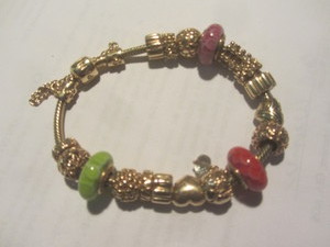 lot 51 image: Pandora Charm Bracelet, 14K Gold