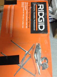 lot 118 image: RIDGID 9 Amp Corded 7 in. Wet Tile Saw with Stand in good conditions