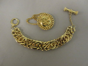 ST JOHN PIN AND A CHUNKY CHANEL BRACELT