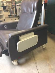 lot 104 image: WOW MSRP $3000 Winco With Dual Swingaway Arms (Easy Access For Wheelchair Patients) Carecliner Reclining Mobile Geri Recovery Chair With Heat & Massage - Great Working Condition Has Trays On Both Sides