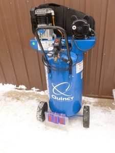 Quincy 2 hp 26 gallon air compressor. Looks new. Tested & works. As shown. This item has a reserve.