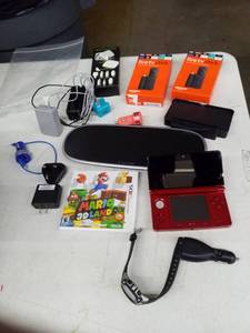 lot 4 image: Nintendo 3DS with Mario 3D Game, Powermat Cordless Charger and Accessories, Fire TV Sticks, Car Chargers, Wall Charger Adapters, Power Bank, And More