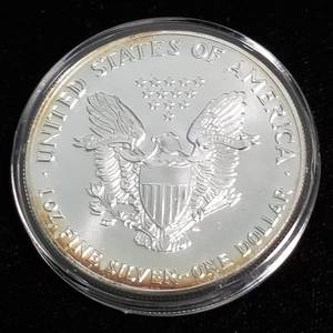 lot 18 image: 1987 AMERICAN SILVER EAGLE 1 TROY OZ. .999 FINE SILVER IN AIRTITE