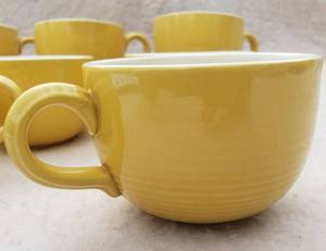 Set of 8 radiating ringed yellow coffee cups.