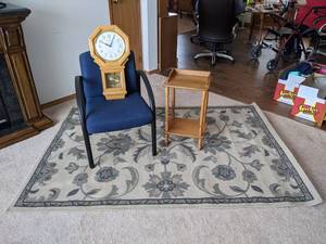 lot 56 image: Area Rug, Side Table, Blue Chair, and Clock