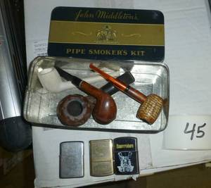 4 vintage pipes and 3 cigarette lig...