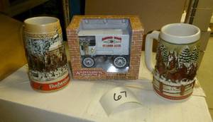 Two budweiser steins and a Anheuser...
